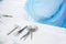 Close-up surgical instruments on a medical table in a clinic during surgery. Metal sterile scissors, clamp, surgical