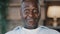 Close up surprised male portrait amazed face American African adult man 60s senior businessman grandfather standing at