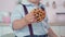 Close-up of sweet cookie in little child`s hand. Unrecognizable cute Caucasian boy holding dessert. Childhood concept.