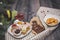 Close-up of sweets on a white plate: coconut biscuit, pastila, meringue, cream roses, Turkish delight, next to a broken chocolate