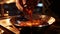 A close-up of a Swiss chocolatier\'s hand tempering a bowl of molten chocolate, capturing the glossy, velvety texture