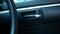 Close-up of switch electric lock doors working while driver`s hand pressing button in car for safety. Technology and transportatio