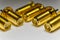 Close-up of symmetric aligned gold plated SMA male connectors electronics components in partial focus white background