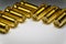 Close-up of symmetric aligned gold plated SMA male connectors electronics components in partial focus white background