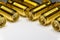 Close-up of symmetric aligned gold plated SMA male connectors electronics components in partial focus white background