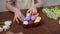 Close-up on a table with items to create a composition for Easter. Women's hands arrange objects on the table