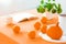 Close-up on table with oranges and pumpkin in dining room interior with plant and book