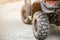 Close-up tail view of ATV quad bike. Dirty whell of AWD all-terrain vehicle. Travel and adventure concept.Copyspace.Toned