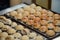 Close up on Takoyaki balls being cooked in a special pan