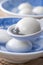 Close up of tangyuan in a bowl on gray table, food for Winter Solstice