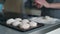 Close-up of a tasty cutlets, a female cook cooks meatballs, dipping cutlets of minced meat in flour and spreading it on