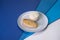 Close up of  Tasty roasted chicken fillet on gray plate with boiled white rice served in culinary ring on colorful blue background