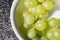 Close up of tasty whine grapes in white bowl