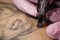 Close-up of a tattoo needle. The process of the tattoo master. Pink women`s protective gloves.