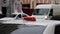 Close up of taxi orange roof sign with checkers on background of cars