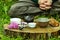 Close-up of tea set on wooden table with clay pot and bawls.