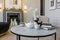 close-up of a tea table setting in a modern living room with a marble fireplace in a chic bright interior of a huge apartment