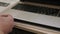 Close-up of technician repairing laptop at desk. Computer repair.