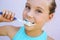 Close up of teen brushing teeth.