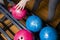 Close-up on teen children hand holding bowling ball against bowling alley - Image. Cheerful Kids are  ready to play - Image.  The