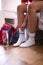 Close Up Of Teenage Girl At Home In Bedroom Putting On Sports Clothing Ready For Exercise