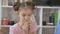 Close up of a teenage girl on the living room floor eating pizza.