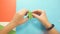 Close-up of teenager`s hands working with paper in creative Studio, Child performs origami