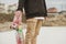 Close up Teenager standing in a right side hoodie holding a hand skateboard on the background slum