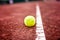 Close-up of tennis ball on the clay court