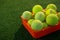 Close up of tennis balls in orange container