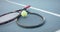 Close up of tennis rackets and ball on outdoor tennis court, slow motion