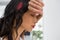 Close up of tensed businesswoman with eyes closed leaning on wall