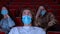 Close up of terrified young man wearing medical mask while watching movie at the cinema. Media. Portrait of a handsome