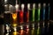 close-up of test tubes and beakers, with colorful liquid inside