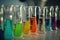 close-up of test tubes and beakers, with colorful liquid inside