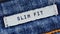 Close-up of a textile label with the inscription `Slim Fit`