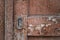 Close-up texture of old dark wooden entrance. Background of rough distressed door leafs. Shabby scratched natural timber