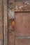 Close-up texture of old dark wooden entrance. Background of rough distressed door leafs. Shabby scratched natural timber