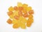 Close-up texture of orange and yellow multivitamin gummies on white background.  Healthy lifestyle concept