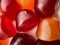 Close-up texture of red, orange and purple multivitamin gummies. Healthy lifestyle concept