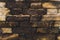 Close-up Textured background of old faded bricks stained with black oil. A brick gradient between dirty black and light