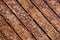 Close-up of textured brown wooden planks strewn with multicolored confetti in the shape of the moon and stars.