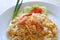 Close-up of Thai style fried rice with shrimp or Khao Pad Goong served on ceramic white plate