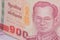 Close up of thailand currency, thai baht with the images of Thailand King. Denomination of 100 bahts