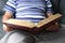 Close-up of thick book in dark red cover, family bible, old man, senior reads, concept eternal values, education, fiction, meet