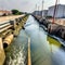 close up of thick industrial wastewater discharge pipes into canals and the sea