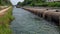 close up of thick industrial wastewater discharge pipes into canals and the sea