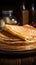 Close up of thin pancakes stacked on a rustic wooden plate