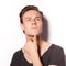 Close up of a thinking young man on white background