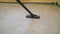 Close-up of thoroughly vacuums the concrete floor. A worker vacuums the floor from industrial concrete dust and cement mud during